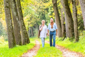 A senior couple on a scenic walk near the best senior memory care in Lincoln