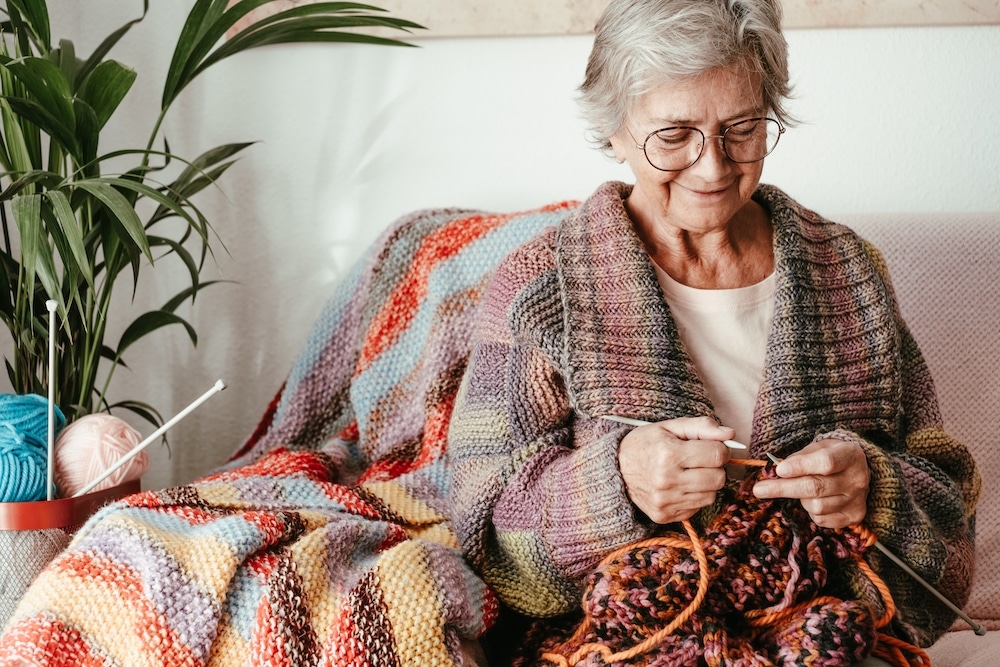 A senior woman knitting