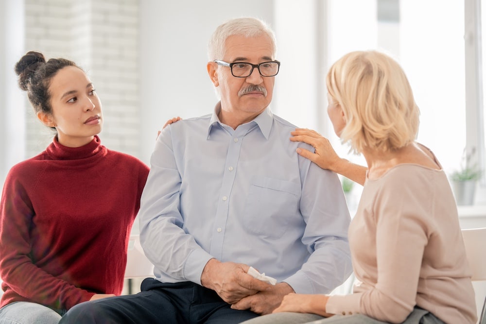 A concerned family talks together with a senior loved one