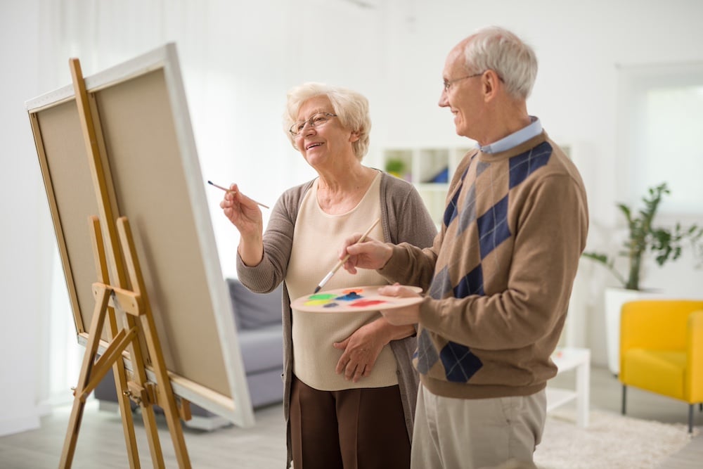 A senior couple taking a painting class as a part of the dementia care services in Cedar Rapids