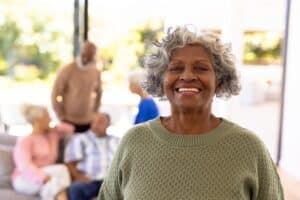 A smiling senior woman with her friends in the background
