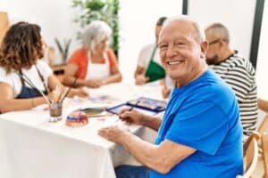 A senior man taking an art class at the Alzheimer's and dementia care in Iowa